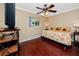 Cozy bedroom featuring wood floors, sunflower accents, and a ceiling fan at 1573 Cumberland Ln, Clearwater, FL 33755