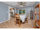 Dining room showcasing wood floors, neutral paint, ceiling fan, and a view to the kitchen at 1573 Cumberland Ln, Clearwater, FL 33755