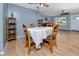 Dining area boasting wood floors, neutral paint, ceiling fan, and a view to the kitchen and living room at 1573 Cumberland Ln, Clearwater, FL 33755