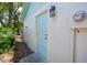 Side door to the building with modern light fixture at 1573 Cumberland Ln, Clearwater, FL 33755