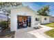 Attached one car garage with open door, white siding and trim, and a concrete driveway and walkway at 1573 Cumberland Ln, Clearwater, FL 33755