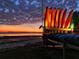 Kayaks lined up near a beach at sunset, showcasing outdoor activities at 1573 Cumberland Ln, Clearwater, FL 33755