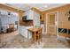 A well-lit kitchen featuring white cabinets and a small dining area at 1573 Cumberland Ln, Clearwater, FL 33755