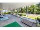 Large screened in patio with a view of the fenced backyard at 1573 Cumberland Ln, Clearwater, FL 33755