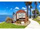 Welcome to Dunedin sign amid lush greenery and palm trees, creating a charming and inviting entrance at 1573 Cumberland Ln, Clearwater, FL 33755