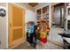 Well-lit storage room with built-in shelving, a door and various items at 1573 Cumberland Ln, Clearwater, FL 33755