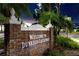 A brick welcome sign to Dunedin Causeway with lush landscaping, palm trees, and inviting street ambiance at 1573 Cumberland Ln, Clearwater, FL 33755