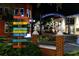 Charming downtown streetscape with colorful signs pointing to local attractions and businesses, illuminated at night at 1573 Cumberland Ln, Clearwater, FL 33755