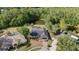 Aerial view of home and pool surrounded by beautiful trees, with a pond nearby at 16014 Amberly Dr, Tampa, FL 33647