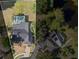 Aerial view of the home showcasing pool, solar panels, and proximity to a serene lake at 16014 Amberly Dr, Tampa, FL 33647