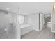 Spacious bathroom featuring a glass-enclosed shower, separate tub, and modern fixtures at 16014 Amberly Dr, Tampa, FL 33647