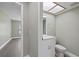 Bathroom with a modern vanity and sink, toilet, and a doorway to another room at 16014 Amberly Dr, Tampa, FL 33647