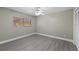 A cozy bedroom with a fan, closet, and window at 16014 Amberly Dr, Tampa, FL 33647