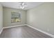 Light-filled bedroom with window and gray laminate flooring at 16014 Amberly Dr, Tampa, FL 33647