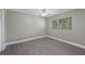 This simple bedroom is a cozy, relaxing space with overhead lighting at 16014 Amberly Dr, Tampa, FL 33647