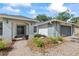 Charming brick home featuring a two-car garage, arched entryway, and nicely landscaped front yard at 16014 Amberly Dr, Tampa, FL 33647