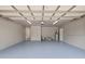 Garage featuring a painted floor, storage space, and water heater at 16014 Amberly Dr, Tampa, FL 33647