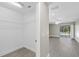 Bright hallway with walk-in closet and views of the living space and outdoor pool through sliding glass doors at 16014 Amberly Dr, Tampa, FL 33647