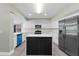 A kitchen view showcases white cabinets, quartz counters, an island, and stainless appliances at 16014 Amberly Dr, Tampa, FL 33647