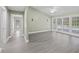 Living room with hardwood floors and sliding glass doors that provide access to the backyard pool at 16014 Amberly Dr, Tampa, FL 33647