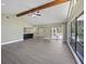 A spacious living room boasts a kitchen view, and access to an outdoor area at 16014 Amberly Dr, Tampa, FL 33647