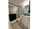 Compact full bathroom with a glass enclosed shower, neutral vanity, and coordinated rug at 16400 Gulf Blvd # 307, North Redington Beach, FL 33708