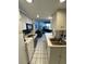 Quaint kitchen leads to an open concept living space and features white cabinetry and appliances at 16400 Gulf Blvd # 307, North Redington Beach, FL 33708