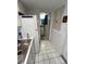 Long galley style kitchen with tile floor connects to the full bathroom at 16400 Gulf Blvd # 307, North Redington Beach, FL 33708