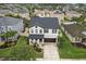 Aerial view of the charming two-story home with lush landscaping in a Gathering-friendly neighborhood with tree-lined streets at 1844 Odiorne Point Ln, Wesley Chapel, FL 33543