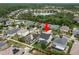 Aerial view of a suburban neighborhood showcasing a home with a dark roof and well-maintained yard at 1844 Odiorne Point Ln, Wesley Chapel, FL 33543