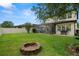 Large, well-maintained backyard with a fire pit and a screened-in patio for outdoor enjoyment at 1844 Odiorne Point Ln, Wesley Chapel, FL 33543