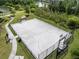 Aerial view of outdoor community basketball court surrounded by lush greenery and a walking path at 1844 Odiorne Point Ln, Wesley Chapel, FL 33543