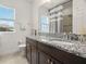 Bathroom featuring a granite vanity, a large mirror, and natural light at 1844 Odiorne Point Ln, Wesley Chapel, FL 33543