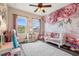Charming bedroom with light walls, ceiling fan, light hardwood floors, and decorative wall art at 1844 Odiorne Point Ln, Wesley Chapel, FL 33543