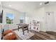 Versatile bonus room with a foosball table, play kitchen, wood floors, and plenty of natural light at 1844 Odiorne Point Ln, Wesley Chapel, FL 33543