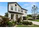 Charming two-story home featuring manicured landscaping, a covered porch and a two-car garage at 1844 Odiorne Point Ln, Wesley Chapel, FL 33543