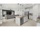 Open-concept kitchen and living space with stainless appliances and dark accent wall at 1844 Odiorne Point Ln, Wesley Chapel, FL 33543