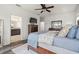 Bright main bedroom featuring wood floors, ceiling fan, walk-in closet, and ensuite bathroom at 1844 Odiorne Point Ln, Wesley Chapel, FL 33543