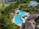 Aerial view of community pool surrounded by lush landscaping and walking trails at 1844 Odiorne Point Ln, Wesley Chapel, FL 33543