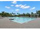 Large community swimming pool with a sundeck surrounded by mature landscaping and a gazebo at 1844 Odiorne Point Ln, Wesley Chapel, FL 33543