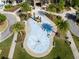 Aerial view of the community water feature surrounded by lush landscaping, seating, and beautiful palm trees at 1844 Odiorne Point Ln, Wesley Chapel, FL 33543