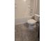 Bathroom showcasing a white tiled tub with a shower, tiled floor, and a modern toilet at 2216 4Th Sw St, Ruskin, FL 33570