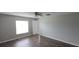 A spacious bedroom featuring wood-look flooring, with a window and ceiling fan at 2216 4Th Sw St, Ruskin, FL 33570