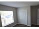 Bedroom featuring wood-look flooring, closet, window, and neutral walls at 2216 4Th Sw St, Ruskin, FL 33570