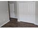 Bedroom with wood-look flooring, closet, and a doorway at 2216 4Th Sw St, Ruskin, FL 33570