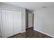 A bright bedroom featuring hardwood-style floors and a large closet with bi-fold doors at 2216 4Th Sw St, Ruskin, FL 33570