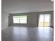 Open living room area featuring a large window, sliding doors, and tile flooring at 2216 4Th Sw St, Ruskin, FL 33570