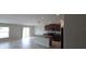 A wide-open floor plan with kitchen island, tile floors, a sliding glass door and stainless steel appliances at 2216 4Th Sw St, Ruskin, FL 33570