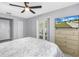 Bright bedroom featuring French doors, neutral decor, and a ceiling fan at 2270 Amherst Ave, Spring Hill, FL 34609