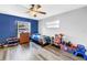 Bedroom featuring wood floors and blue accent wall at 2270 Amherst Ave, Spring Hill, FL 34609